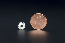 Gearwheels in comparison to a Euro Cent coin